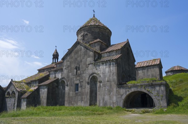 Stone monastery with several structures and domes in front of a wide meadow, Haghpat monastery, Haghpatavank, town of Haghpat, UNESCO World Heritage Site, Lorikeet province, Armenia