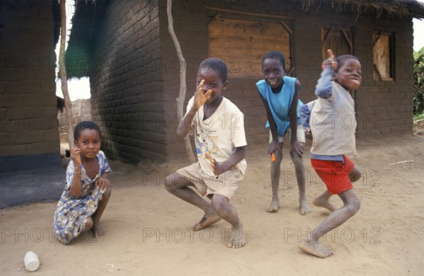 Children in front of a clay hut on the side of the road, girls, boys, Salima, Malawi, Africa, June 2000, vintage, retro, old, historic