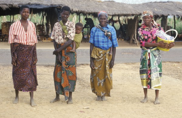 Local woman with a toddler pose for the camera in front of a street market, Salima, Malawi, Africa, June 2000, vintage, retro, old, historic