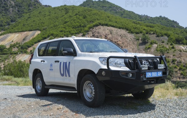 White UN SUV parked in front of a natural mountain landscape, Toyota of UNHCR, The UN Refugee Agency, Lorikeet Province, Armenia