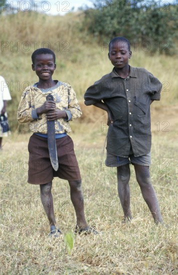 Portraits of two boys, one of them holding a large knife, Bwangu Mzimba, Malawi, Africa, June 2000, vintage, retro, old, historical