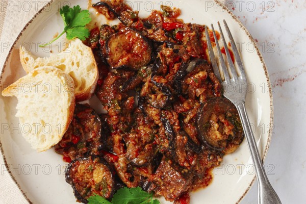 Stewed meat with eggplant is a Georgian dish, on a light background, homemade, no people