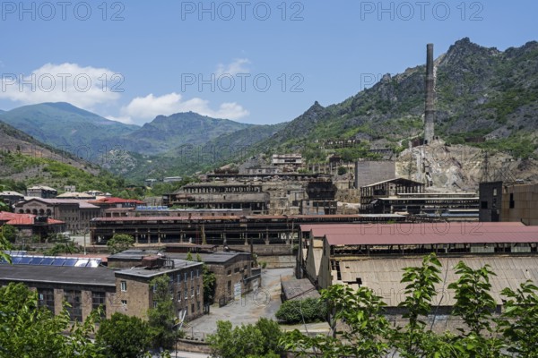 Industrial plant in a mountainous area with old buildings and chimney surrounded by green hills, former copper smelter, Alaverdi, Alaverdi, Lorikeet province, Armenia
