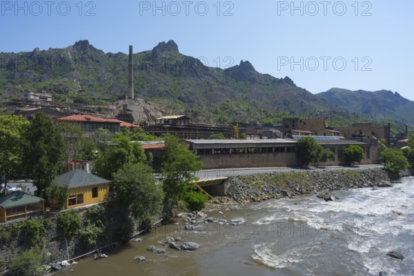 Industrial building on the riverbank surrounded by mountains and green trees, former copper smelter, Alaverdi, Debed River, Lorikeet province, Armenia