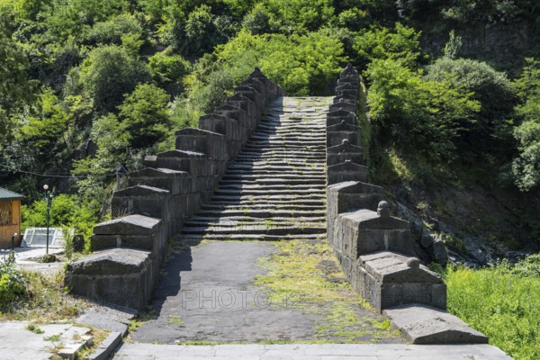 Historic stone staircase leads through a wooded landscape covered with moss, bridge, Sanahin bridge over the Debed river, Alaverdi, Alaverdi, Lorikeet province, Armenia