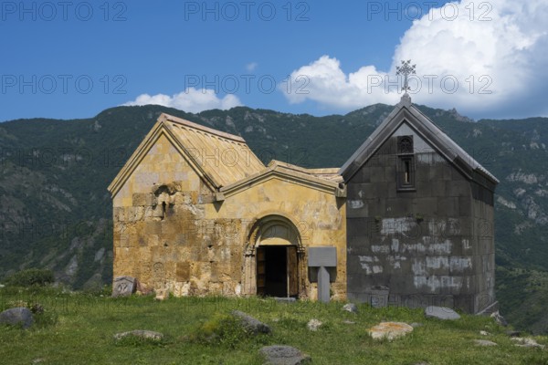 Historic church in the middle of a green mountain area under blue sky with clouds, Saint Nshan Church on Debed Gorge, Lorikeet Province, Armenia