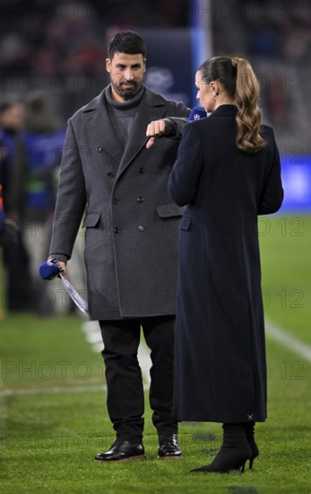 DAZN presenter Laura Wontorra and TV expert Sami Khedira with microphone, logo, gesture, thumbs down, Champions League, Allianz Arena, Munich, Bayern, Germany