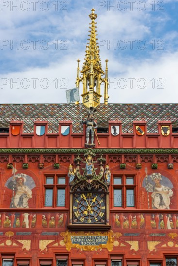 Exterior view with a magnificent clock at the Red Town Hall, Market Square, Basel