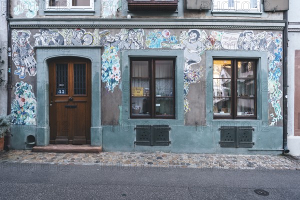 House faÃ§ade with paste-up street art, Basel