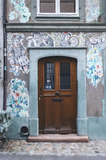 House faÃ§ade with paste-up street art, Basel