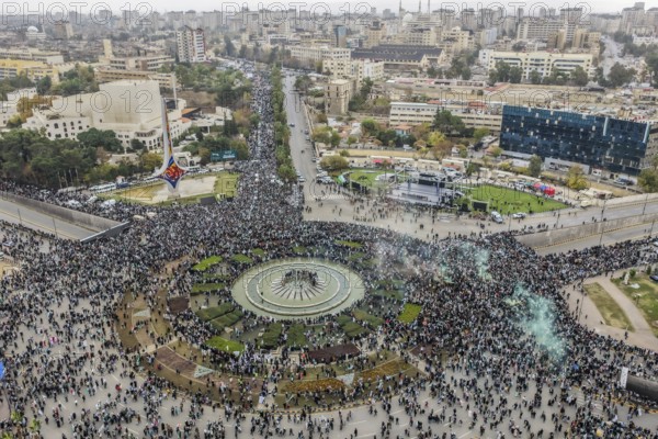 Damascus, Syria â€“ December 08, 2025: A drone view shows thousands of people gathering in the iconic Umayyad Square in central Damascus, raising Syrian flags to celebrate the first anniversary of the fall of the Assad regime and the end of a devastating 14-year war that claimed hundreds of thousands of lives, Damascus, Damascus, Syria