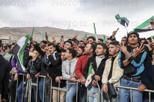 Damascus, Syria â€“ December 08, 2025: Thousands of Syrians gather in the iconic Umayyad Square in central Damascus, raising Syrian flags to celebrate the first anniversary of the fall of the Assad regime and the end of a brutal 14-year war that claimed hundreds of thousands of lives, Damascus, Damascus, Syria