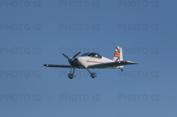 Stunt aerobatic plane performing stunts in blue sky. Concept of speed, difficulty, precision, risk, challenge
