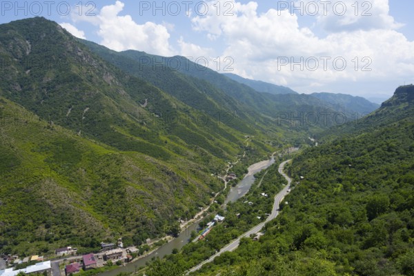 A valley with a river and a road nestled in green hills and under a cloudy sky, Debed River, Debed Gorge near Sanahin, Lorikeet Province, Armenia
