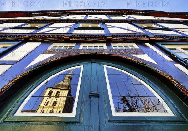 Door detail on the half-timbered house Altes brewhouse with the reflection of the church tower of the Great St. Mary's Church, Lippstadt, North Rhine-Westphalia, Germany