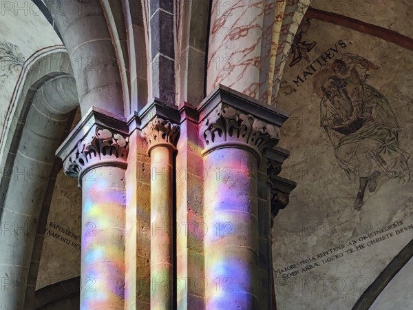 Great St. Mary's Church, interior view with color spots on the pillars due to the incoming light of the stained glass windows, Lippstadt, North Rhine-Westphalia, Germany