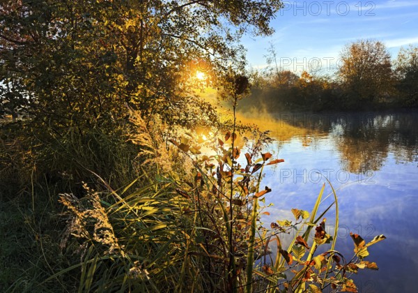 Atmospheric sunrise over the Lippe river in autumn, Lippeaue, Lippstadt, North Rhine-Westphalia, Germany