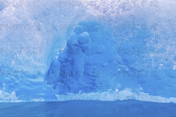 Close-up of blue ice floe calved from Lilliehöökbreen glacier drifting in the Lilliehöökfjorden, fjord in Albert I Land, Spitsbergen / Svalbard