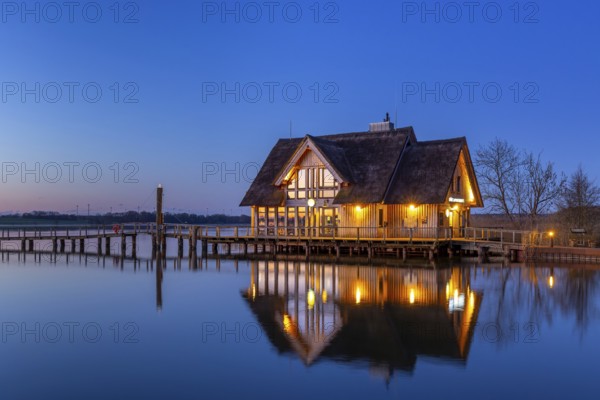 LakehouseÂ°54, bistro and bar on Lake Hemmelsdorf / Hemmelsdorfer See at sunrise in spring near LÃ¼beck, Schleswig-Holstein, Germany
