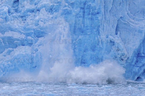 Ice chunk breaking from edge of the calving Lilliehöökbreen glacier into Lilliehöök Fjord, Lilliehöökfjorden, Albert I Land, Spitsbergen, Svalbard
