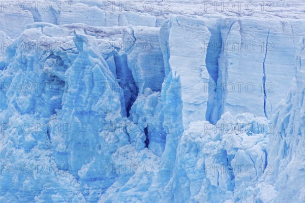Calving glacier wall showing crevasses, deep cracks in blue ice, Lilliehöök Fjord, Krossfjorden in Albert I Land, Spitsbergen, Svalbard