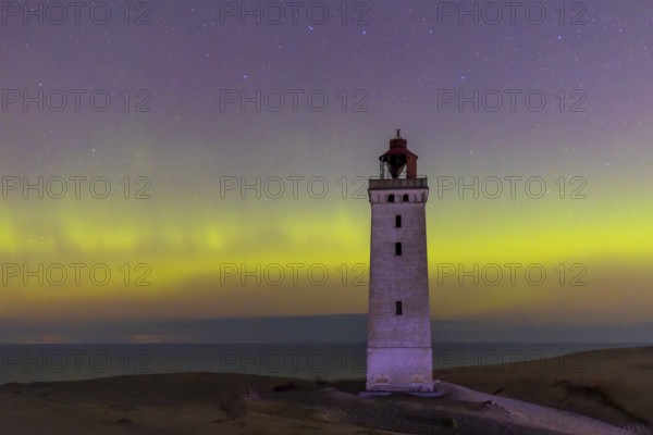 Northern lights / Aurora borealis over Rubjerg Knude Fyr, lighthouse in the dunes on top of LÃ¸nstrup Klint at night, HjÃ¸rring, North Jutland, Denmark