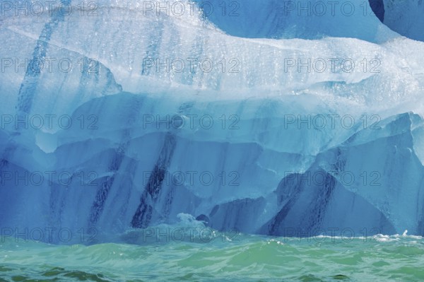 Blue ice pattern from erosion by sea water on base of melting iceberg in the Arctic Ocean at Svalbard / Spitsbergen, Norway