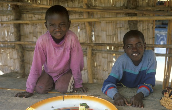 Two boys work at a market in Kande on Lake Malawi, Malawi, Africa, July 2000, vintage, retro, old, historic