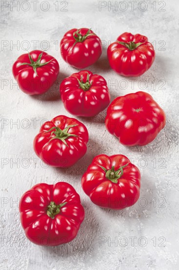 Pink tomatoes scattered on the table, top view, close-up, no people
