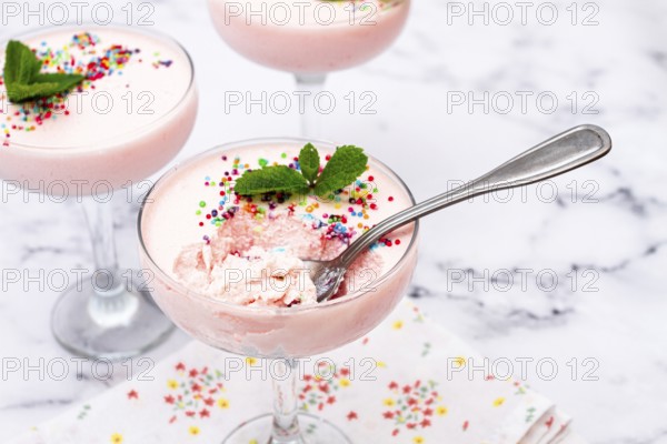 Fruit mousse, made from jelly and cottage cheese, in glasses, decorated with sprinkles and mint, homemade