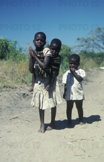 Girl with younger siblings near Kande Beach, Malawi, Africa, July 2000, vintage, retro, old, historic