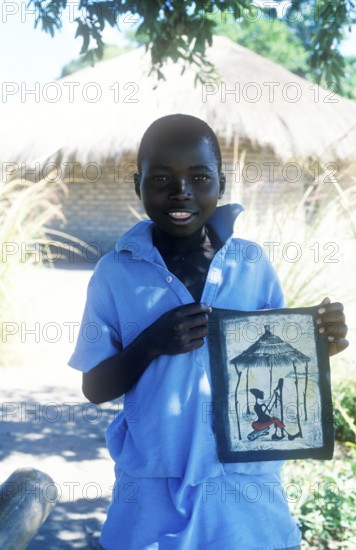 Local boy showing homemade artwork, Kande, Malawi, Africa, July 2000, vintage, retro, old, historic