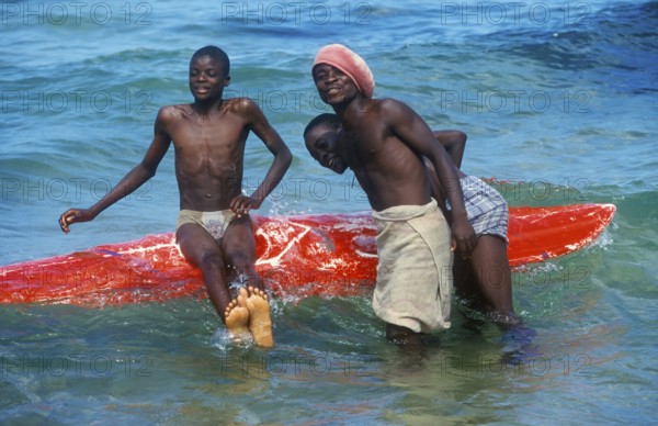 Teenager with surfboard in Lake Malawi, Kande, Malawi, Africa, July 2000, vintage, retro, old, historic