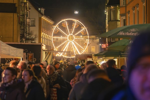 A night-time Christmas market with many visitors and an illuminated Ferris wheel, Christmas market 2025, Nagold, Black Forest, Calw district, Germany