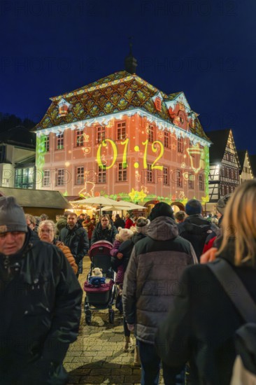 Projection with time on a building during a night-time Christmas market, Christmas market 2025, Nagold, Black Forest, Calw district, Germany