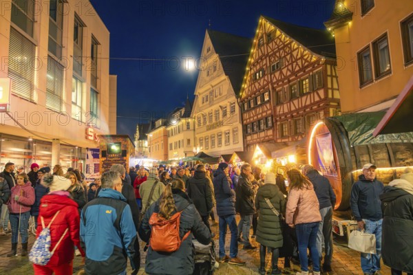 People enjoy the busy Christmas market in a half-timbered house town at night, Christmas market 2025, Nagold, Black Forest, Calw district, Germany
