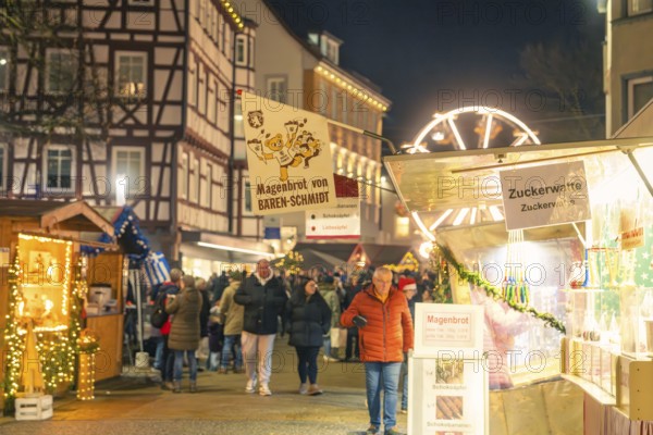 Night market with stalls selling stomach bread and cotton candy, Christmas market 2025, Nagold, Black Forest, Calw district, Germany