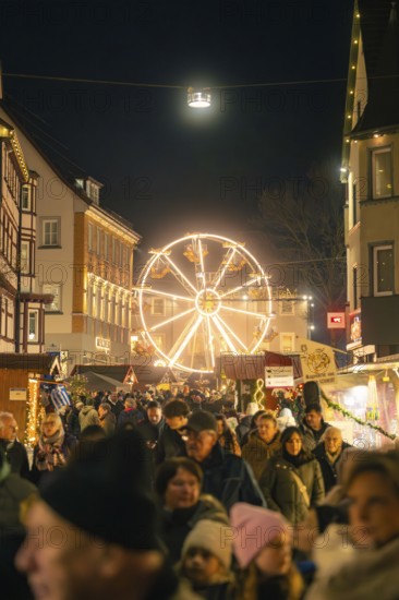 Busy Christmas market at night with illuminated Ferris wheel in the background, Christmas market 2025, Nagold, Black Forest, Calw district, Germany