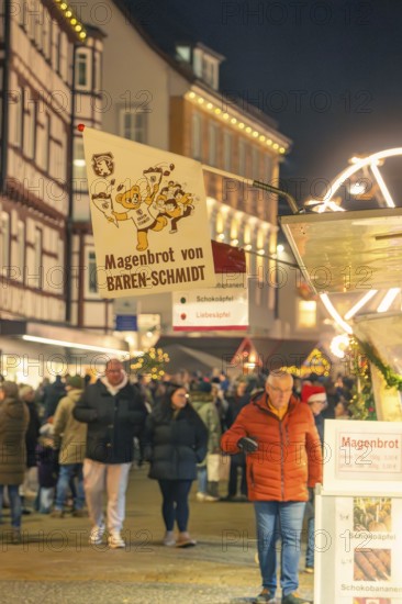 People buy stomach bread at a busy evening Christmas market, Christmas market 2025, Nagold, Black Forest, Calw district, Germany