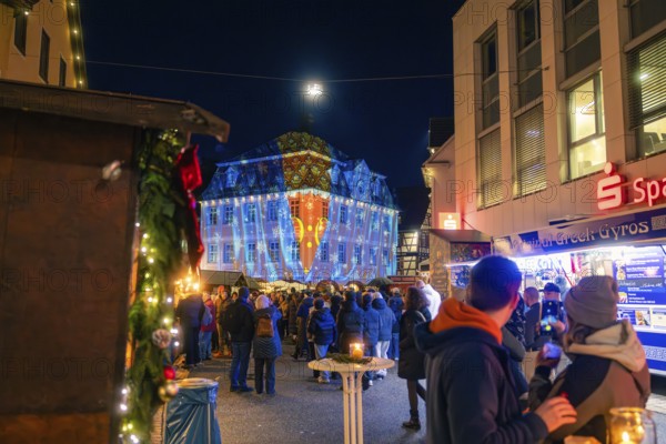 Coloured projections on a building during a night-time visit to the Christmas market, Christmas market 2025, Nagold, Black Forest, Calw district, Germany