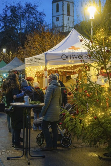 A Christmas market with a tent and lights at night, Aidlingen Christmas market, Böblingen district, Germany