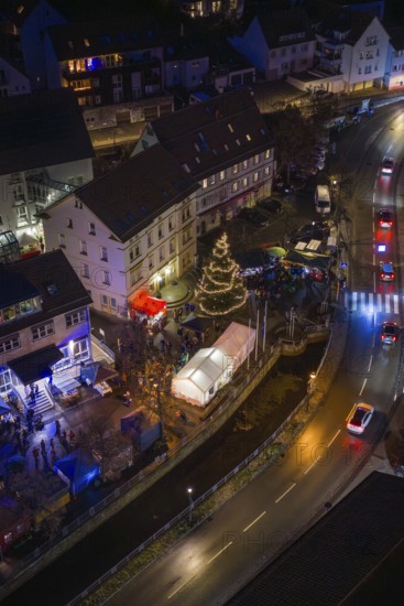 Illuminated street at night with Christmas tree and decorated buildings, Aidlingen Christmas market, Böblingen district, Germany