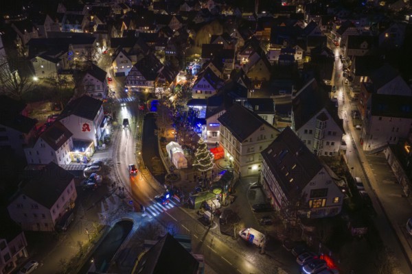 Night view of a Christmas market with glowing lights, roads and decorated Christmas tree, Aidlingen Christmas market, Böblingen district, Germany