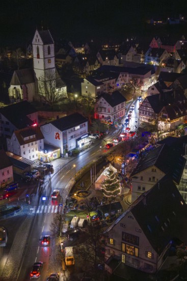 Aerial view of a festively lit village with Christmas lights and church, Aidlingen Christmas market, BÃ¶blingen district, Germany