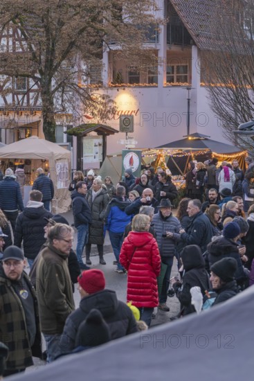 Lively Christmas market with crowds and illuminated stands, Aidlingen Christmas market, Böblingen district, Germany