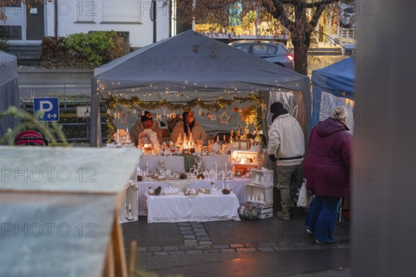 A festively decorated sales tent at a Christmas market with fairy lights and handmade items, Aidlingen Christmas market, Böblingen district, Germany