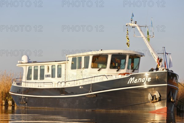 Residential ship on the Peene, tourism, alternative form of living, life on the water with a ship, Peenetal nature park Park, Mecklenburg-Western Pomerania, Germany