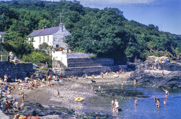 People on beach at Cwm Yr Eglwys, Cwm-yr-Eglwys, Dinas Cross, Pembrokeshire, Wales, UK 15 July 1971