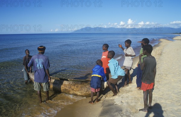Local men and boys with a dugout near Kande Beach on Lake Malawi, Malawi, Africa, July 2000, vintage, retro, old, historic