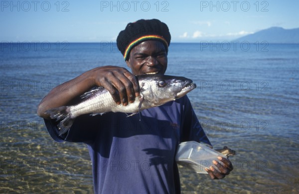 Man showing a big fish, Kande, Lake Malawi, Africa, July 2000, vintage, retro, old, historic